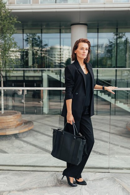 Full length of a middleaged female in black formal wear