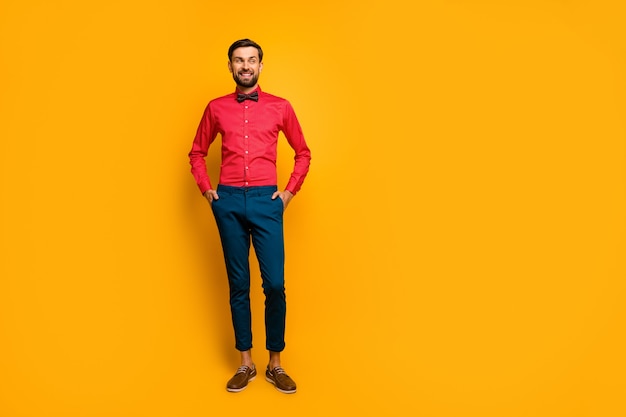 Premium Photo | Full length photo of amazing macho man good mood friendly  smiling look side empty space wear stylish red shirt with bow tie blue pants  shoes