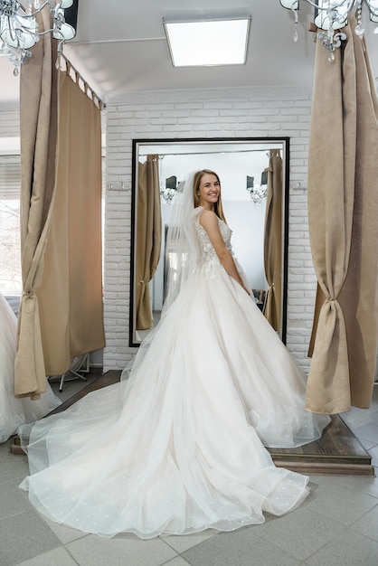 Full length photo of bride in wedding shop