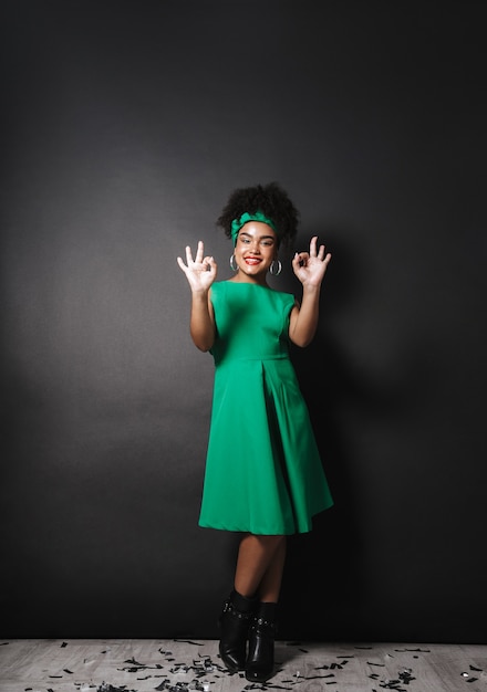 Full length photo of fashion afro american woman wearing green dress standing