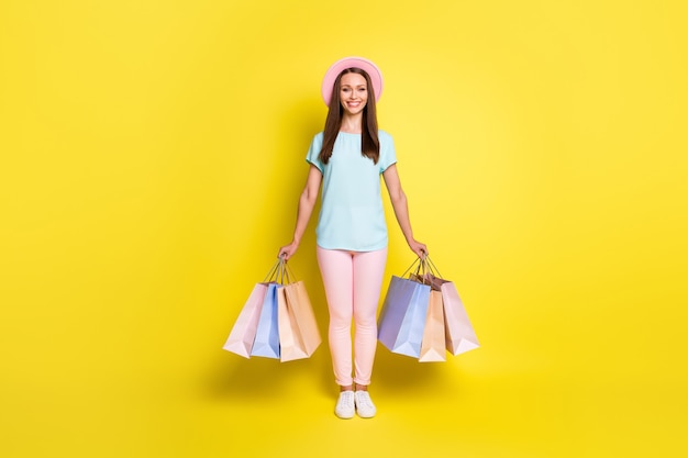 Full length photo of positive tourist girl end her rest relax resort buy family souvenirs hold many bags wear blue pink  pants footwear isolated over bright shine color background