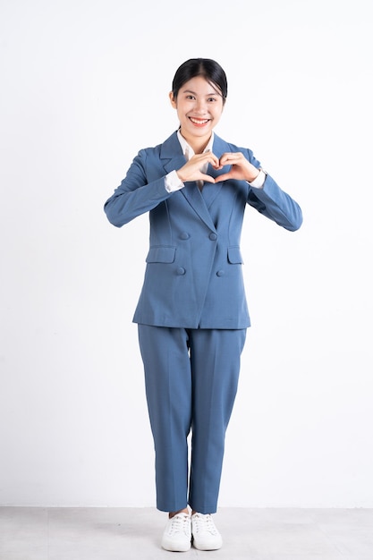 Full length photo of young Asian business woman on background