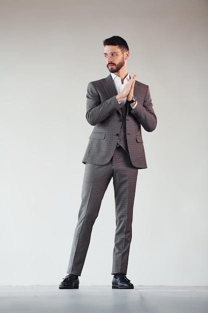 Full length photo of young stylish businessman that is in suit indoors Conception of success