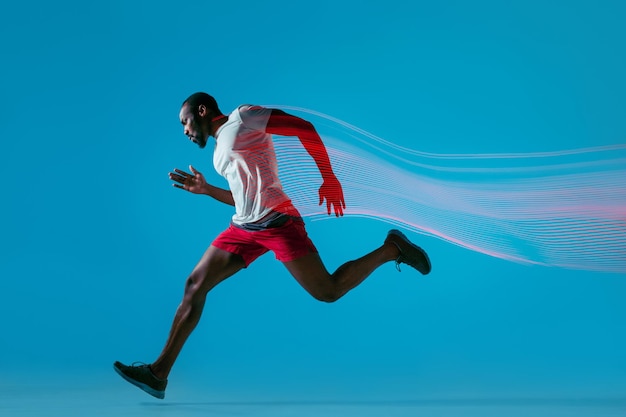 Full length portrait of active young muscular running man,