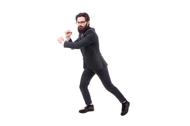 Full length portrait of a bearded businessman pulls an invisible rope, isolated on white background