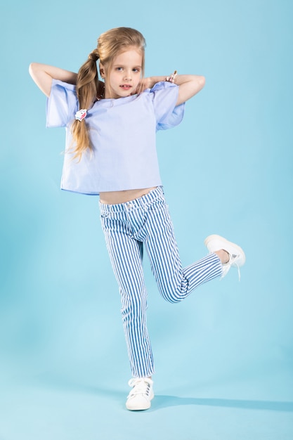 Full-length portrait of a beautiful girl in blue clothes