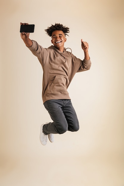 Full length portrait of a cheerful young afro american man