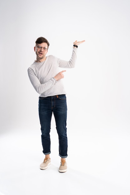 Full length portrait of a cheerful young man wearing casual clothes isolated over white background