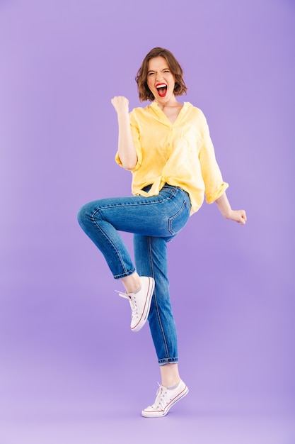 Full length portrait of a cheerful young woman