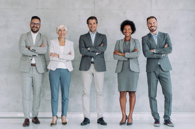 full length portrait of confident multiracial business people standing together in the office