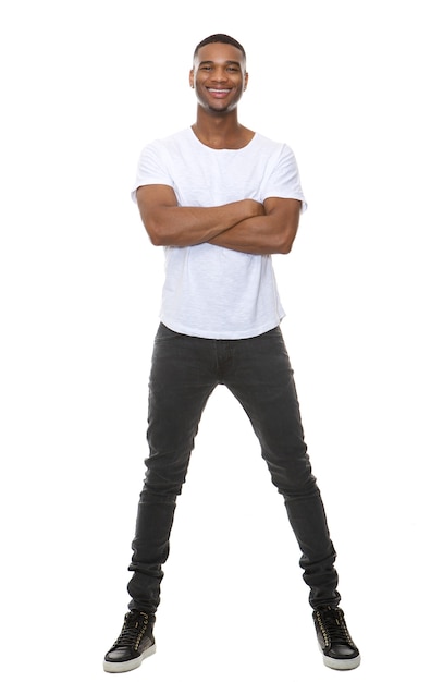 Photo full length portrait of a cool young guy smiling with arms crossed