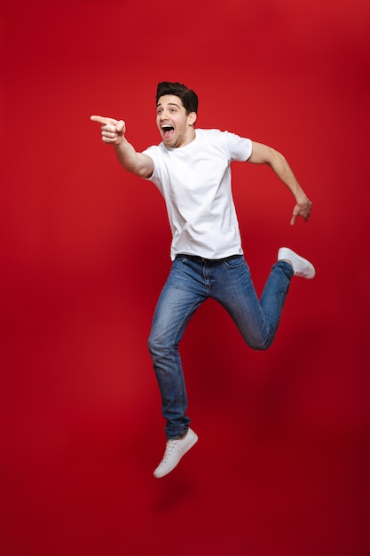 Full length portrait of an excited young man