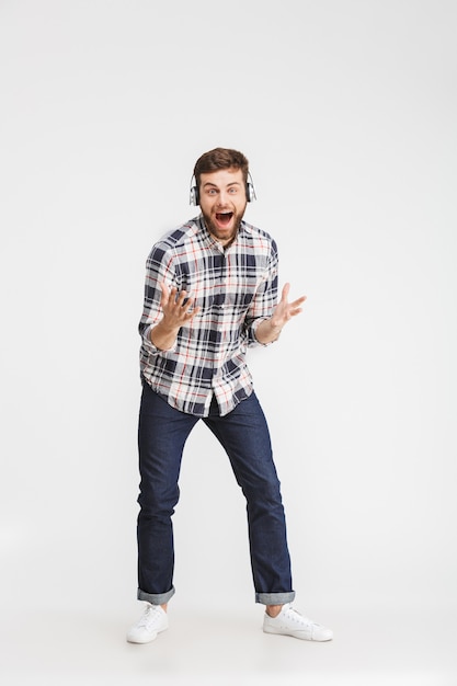 Full length portrait of an excited young man