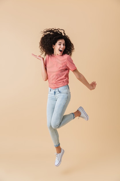 Full length portrait of an excited young woman