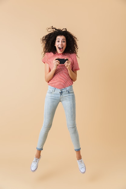 Full length portrait of an excited young woman