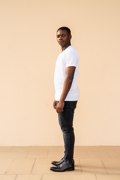 Full length portrait of handsome African man wearing white tshirt