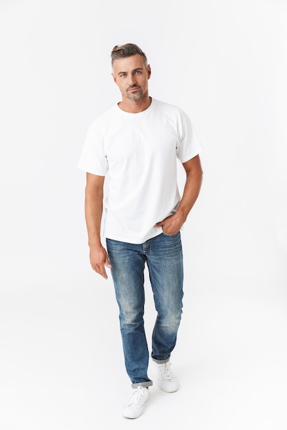 Full length portrait of a handsome casual man standing isolated on white