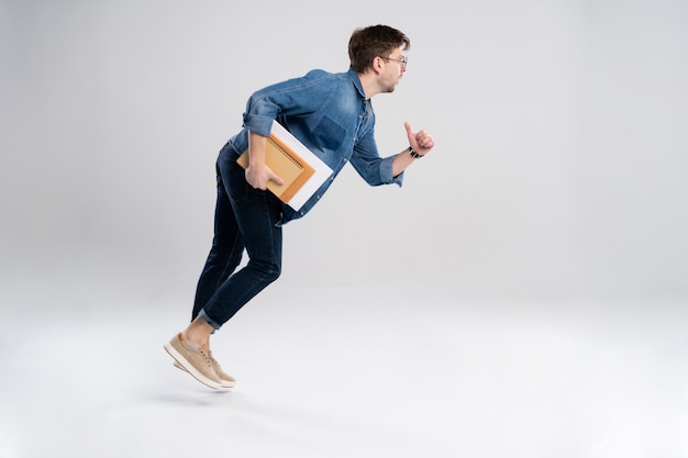 Full length portrait of a happy excited man running isolated