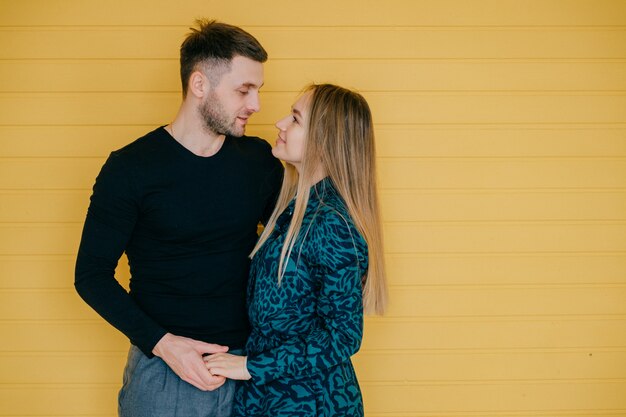 Full length portrait of a happy young couple hugging