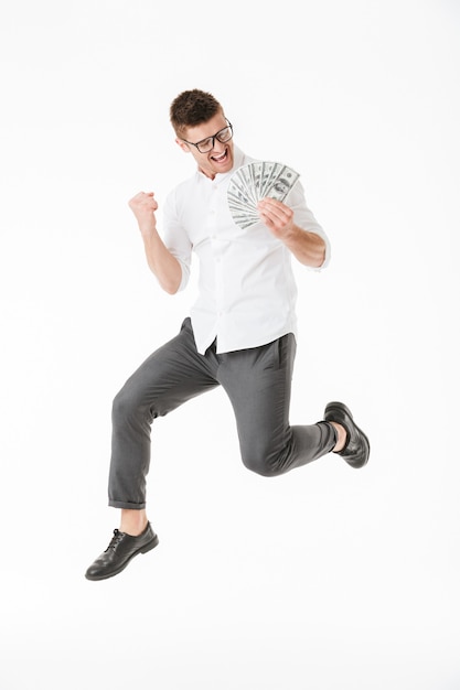 Full length portrait of a happy young man in eyeglasses