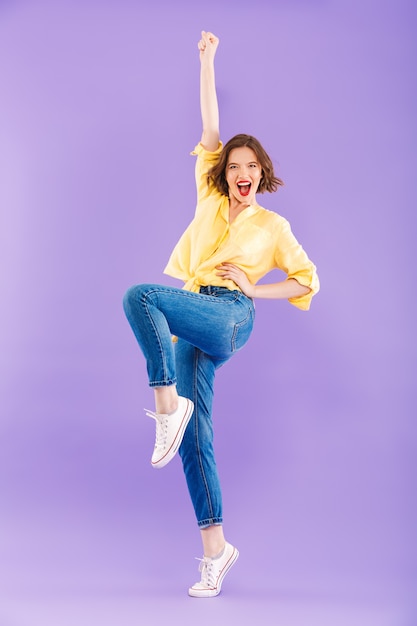 Full length portrait of a joyful young woman