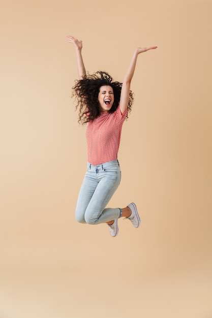 Full length portrait of a joyful young woman