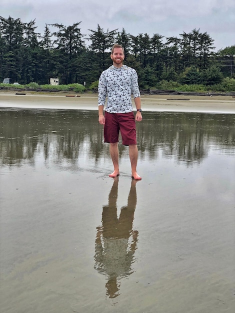 Photo full length portrait of man standing in sea