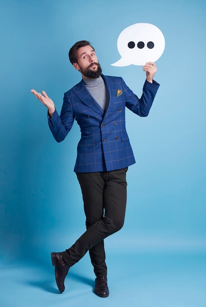 Full length portrait of man with speech bubble posing