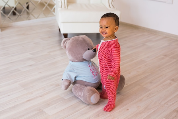 Full length portrait of mixed race baby boy in the home.