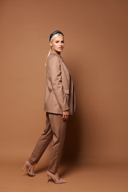 Full-length portrait of a model girl wearing trendy oversize suit