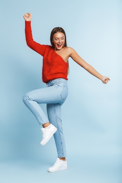 Full length portrait of a pretty young girl standing isolated