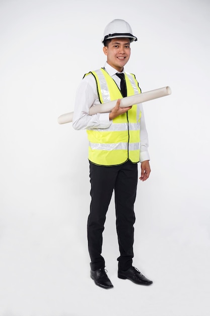 Photo full length portrait of smiling architect holding blueprint while standing against white background