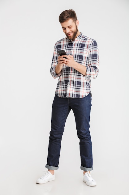 Full length portrait of a smiling young man