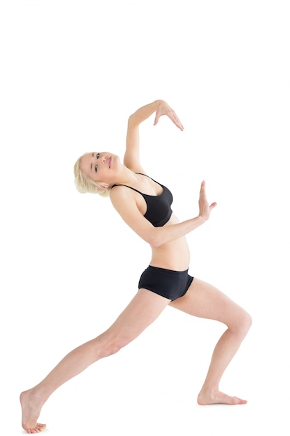 Full length portrait of a sporty young woman dancing