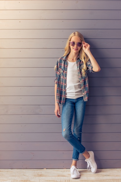 Full length portrait of stylish blonde teenage girl.