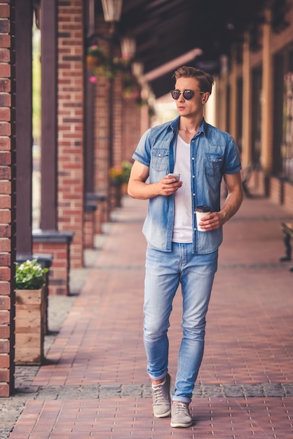 Full length portrait of stylish guy in jeans clothes