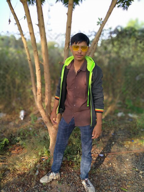 Full length portrait of teenage girl standing in forest