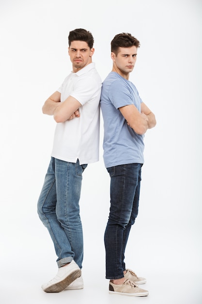 Full length portrait of two angry young men