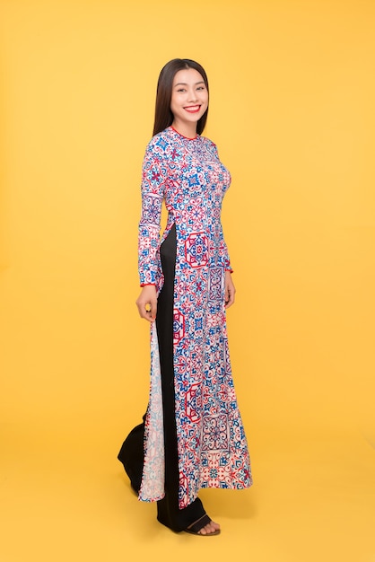 Full-length portrait of Vietnamese girl in ao-dai dress