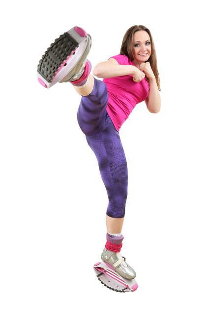 Photo full length portrait of woman doing kangoo jumps on white background