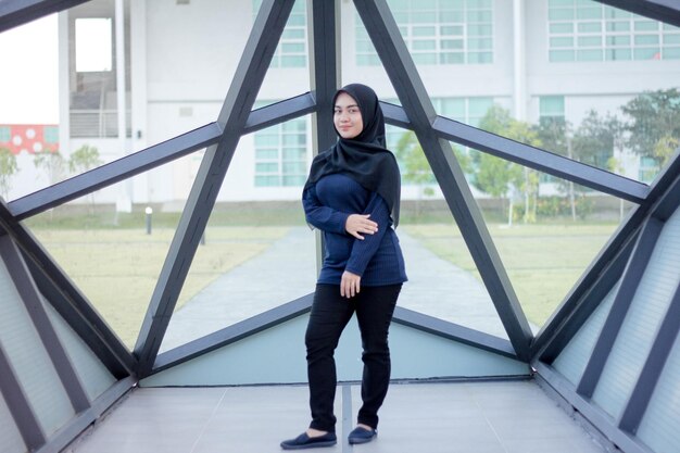 Full length portrait of woman standing in built structure