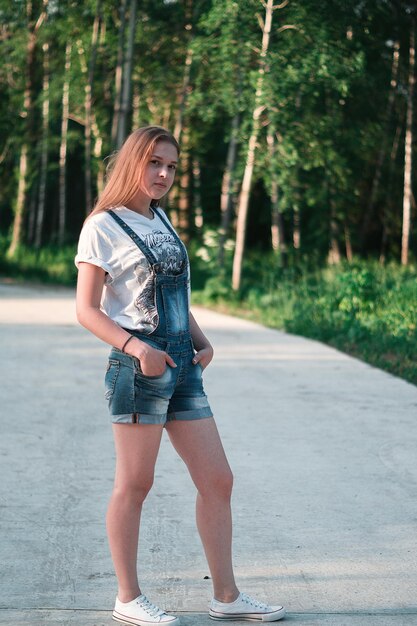 Full length portrait of woman standing on road