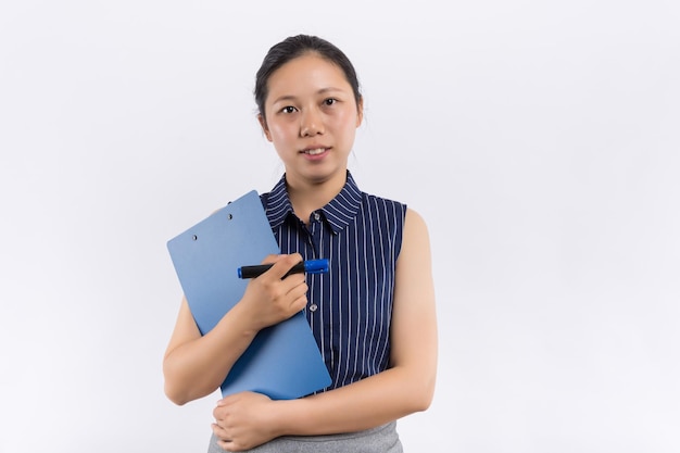 Full length portrait of young Asian female arms crossed and smiling standing isolated on white background