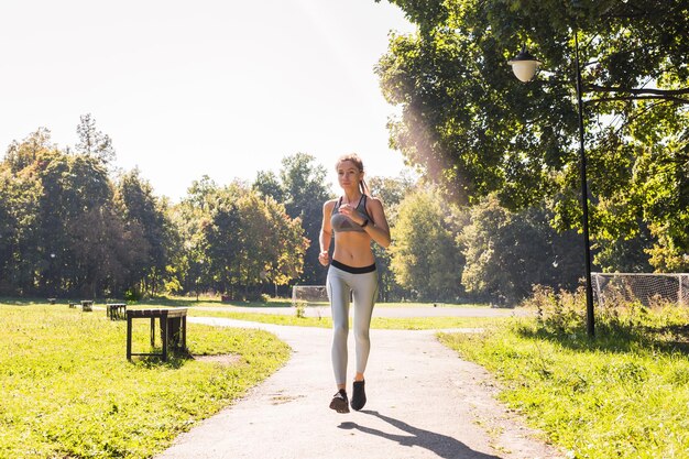 Full length portrait of young woman against trees