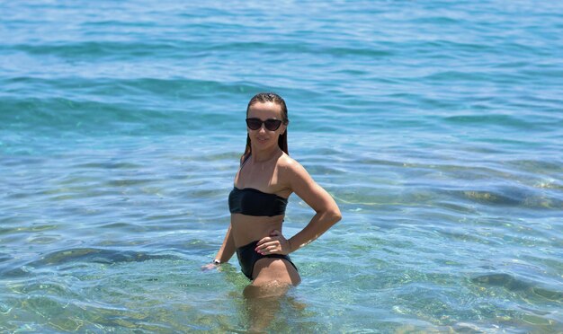 Full length portrait of young woman in sea