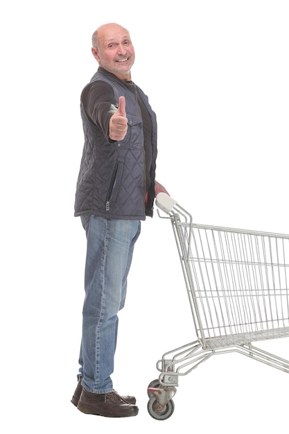 Full length potrait of a gentleman with shopping cart and thumb up