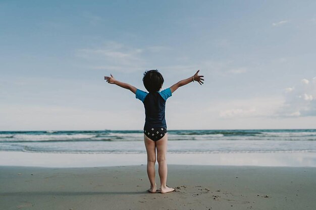 Photo full length rear view of boy standing at beach