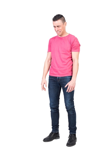 Full length of sad young male with dark hair in t shirt and jeans crying desperately isolated on white background