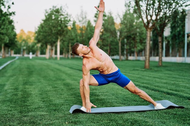 Full length of shirtless man jumping on grass