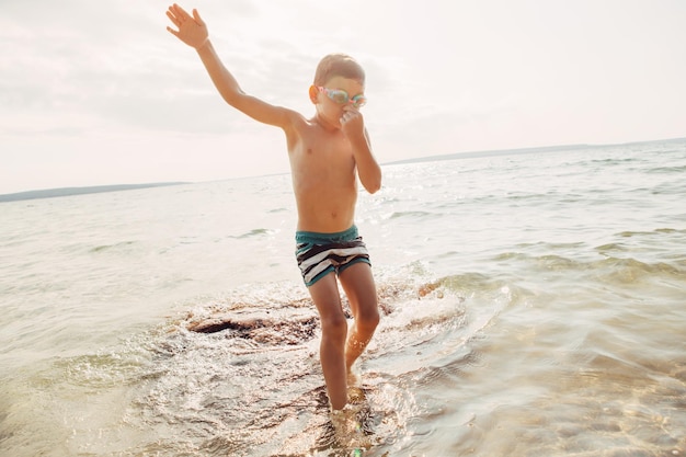 Full length of shirtless man standing on beach